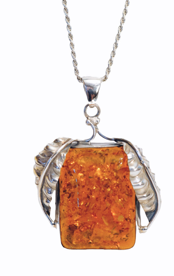 "Elegant silver amber leafy pendant featuring a rich, golden-brown amber stone set in a silver frame with detailed leaf designs on each side, presented on a delicate silver chain."