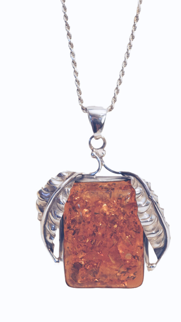 "Elegant silver amber leafy pendant featuring a rich, golden-brown amber stone set in a silver frame with detailed leaf designs on each side, presented on a delicate silver chain."